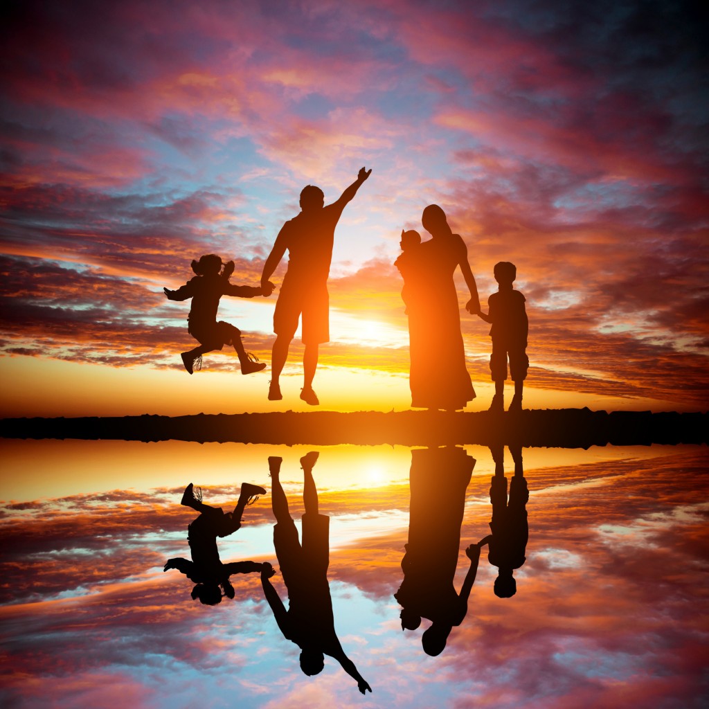 family on a background of the magnificent sunset